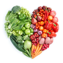 Heart shaped display of green, red healthy foods